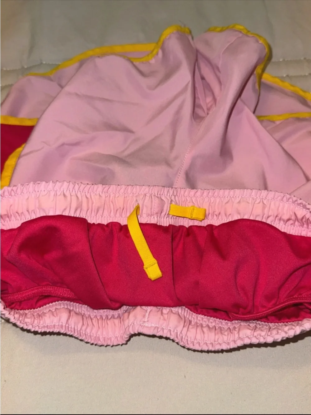 Nike Pink Shorts with Yellow Trim and Red Accents